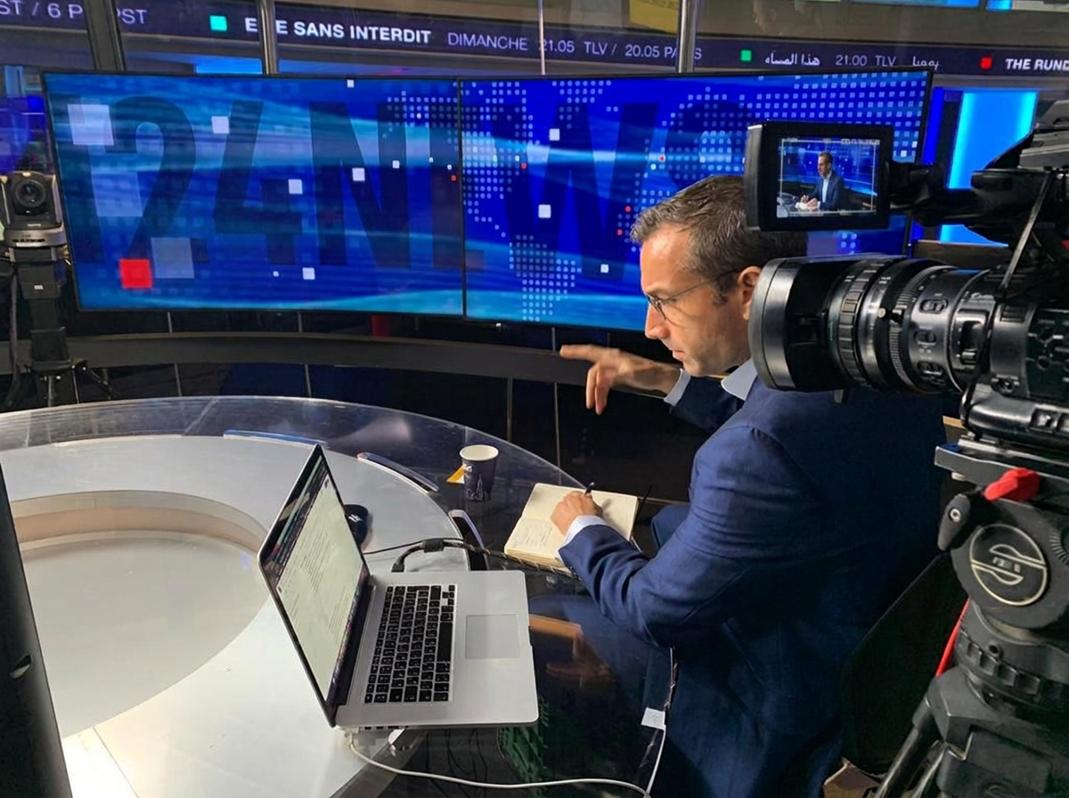 Elliott Gotkine preparing for a live television interview in a news studio